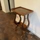Nightstand in the shape of a lyre.