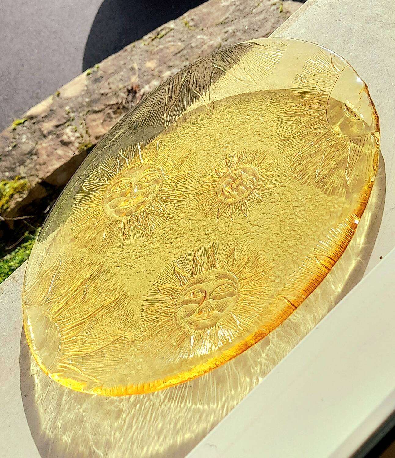 Glass plate decorated with suns, 1980.