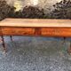 Antique cherry farmhouse table with turned legs and 2 drawers.