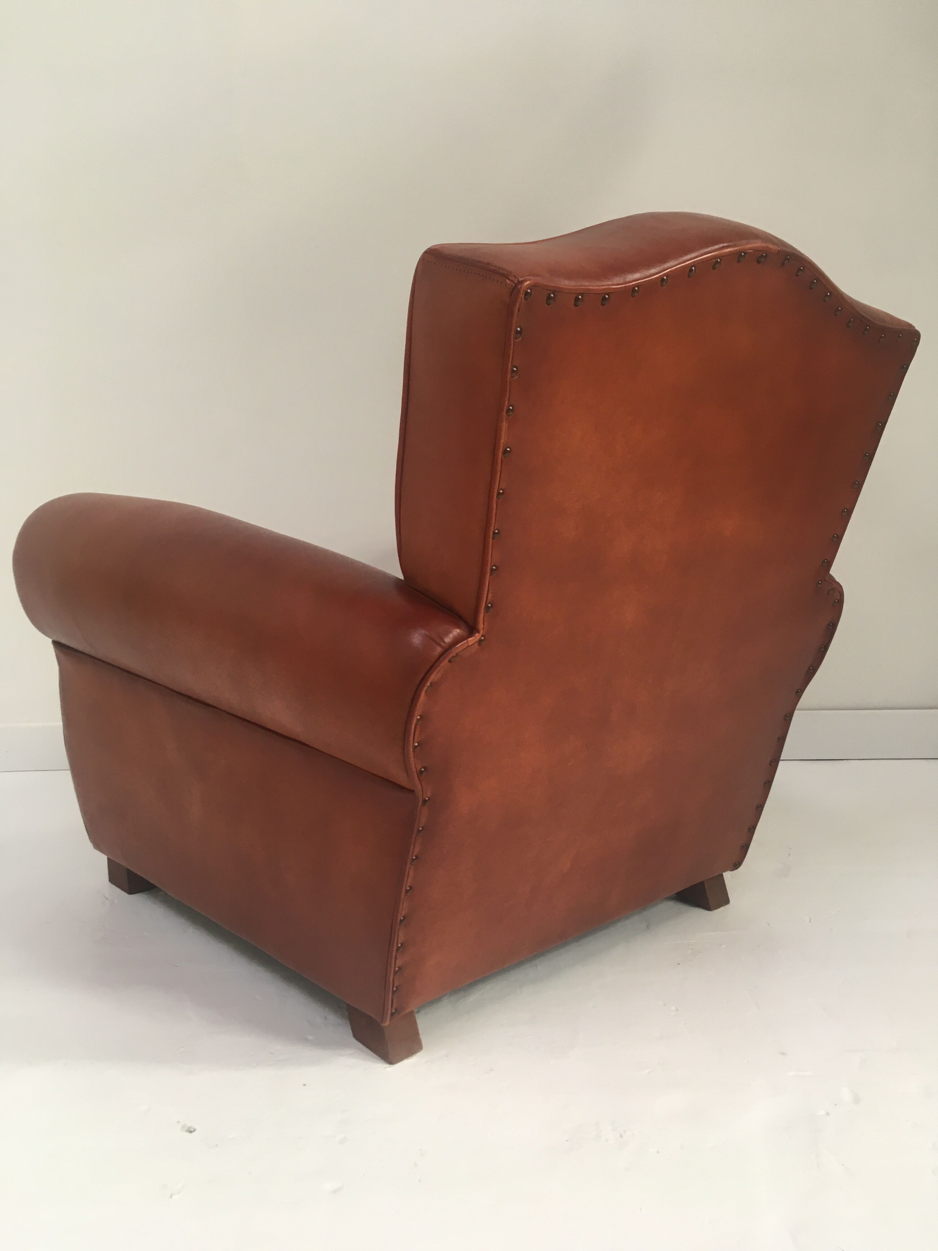 Large club chair in cognac leather