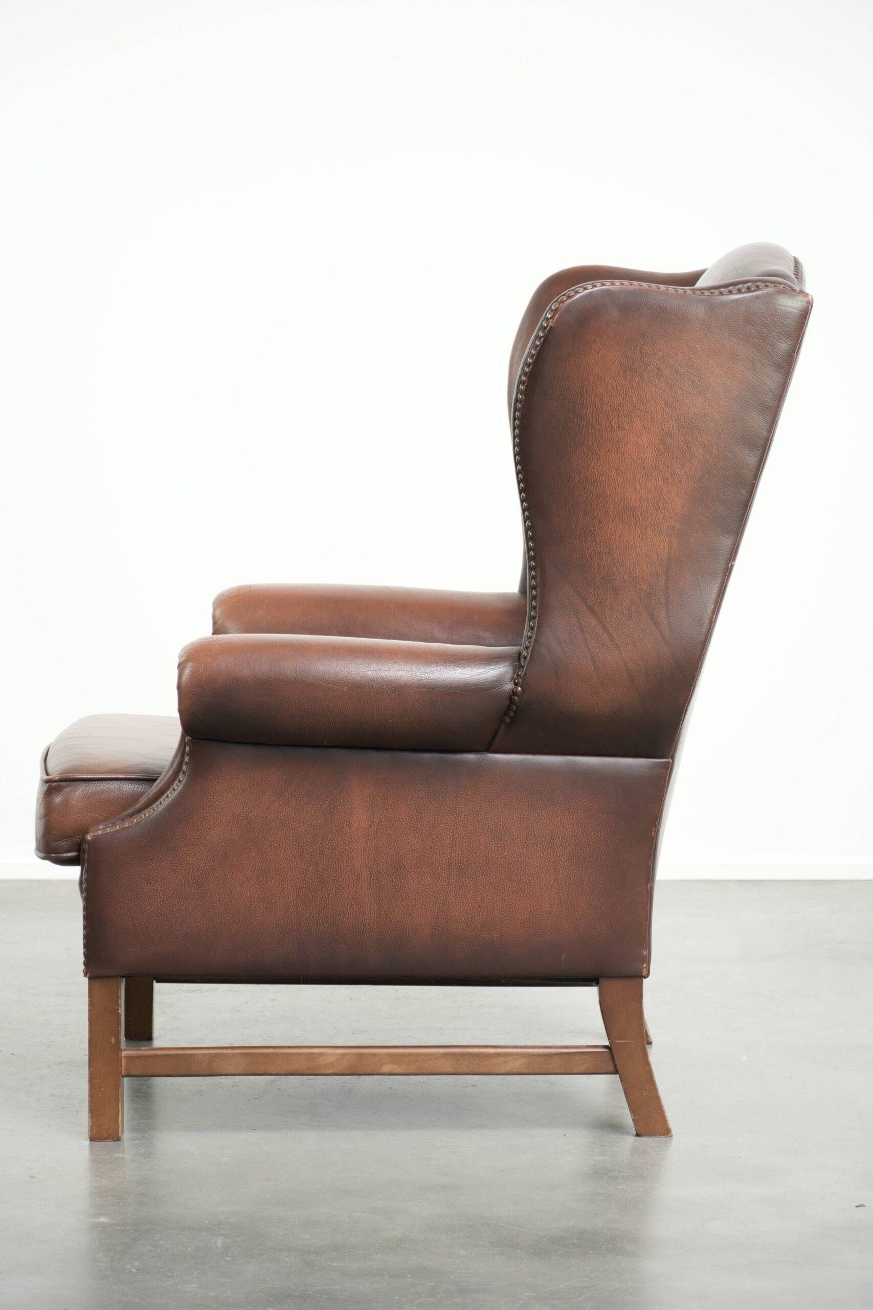 Comfortable cowhide wingback armchair in English style with a timeless look