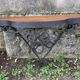 Old wrought iron console with a fleur-de-lis design.