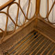Vintage rattan baby cot on wheels.