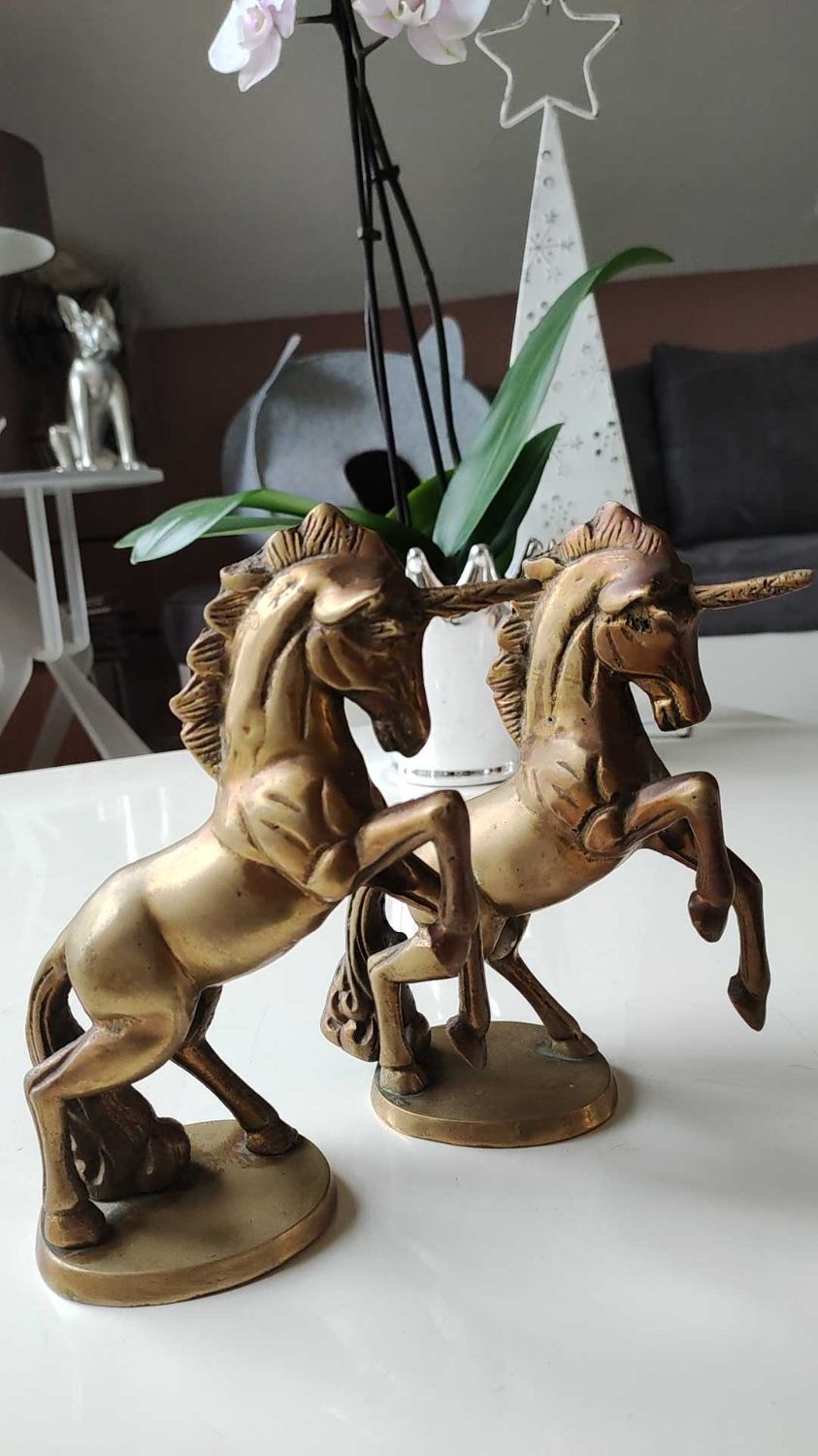 of greenhouse art deco bookends recancing unicorns. solid brass