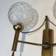 Pair of brass wall lights with glass globes. Around 1970.