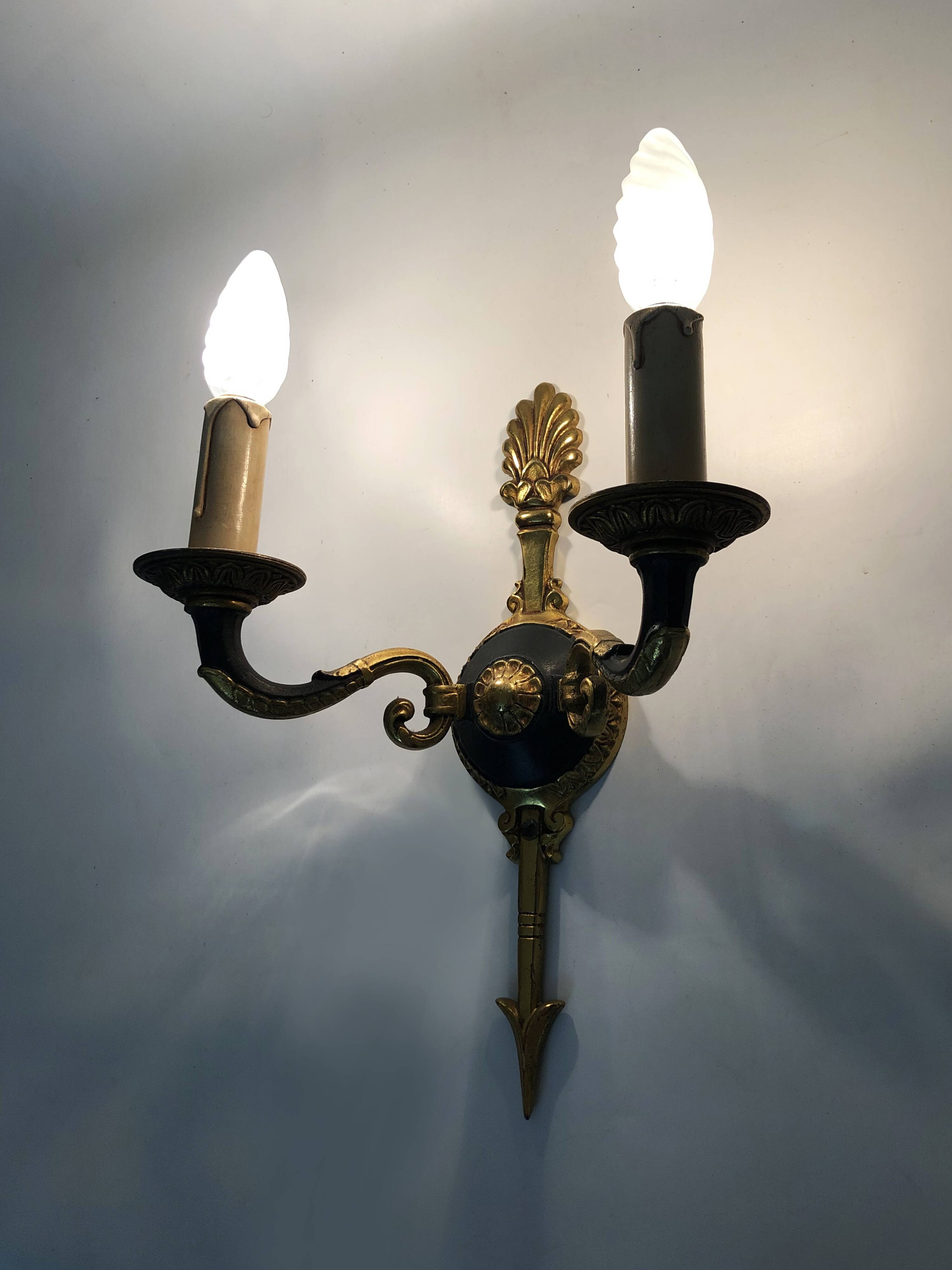 Pair of wall sconces in the Empire style with double lights in bronze.