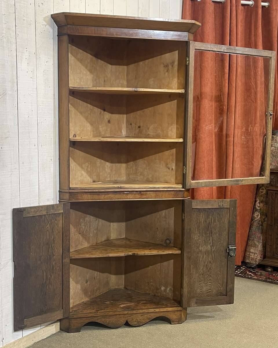 19th-century English corner cabinet in oak, mahogany, and fir.