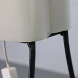 Mid-century modern floor lamp on iron legs with plastic shade and wood accent