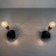 Pair of mid-century bedside lamps in brass and black metal, 1960, Italy.