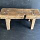 Ancient Chinese farm bench in patinated wood, small rustic stool.