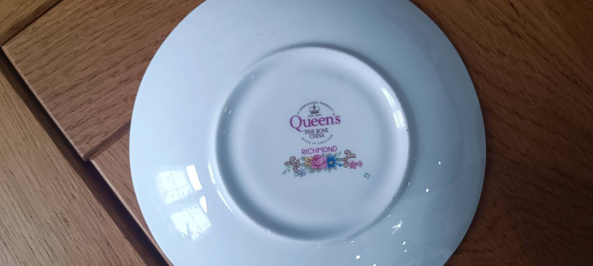 Duo of English porcelain tea cups from Queen's Richmond and spoons.