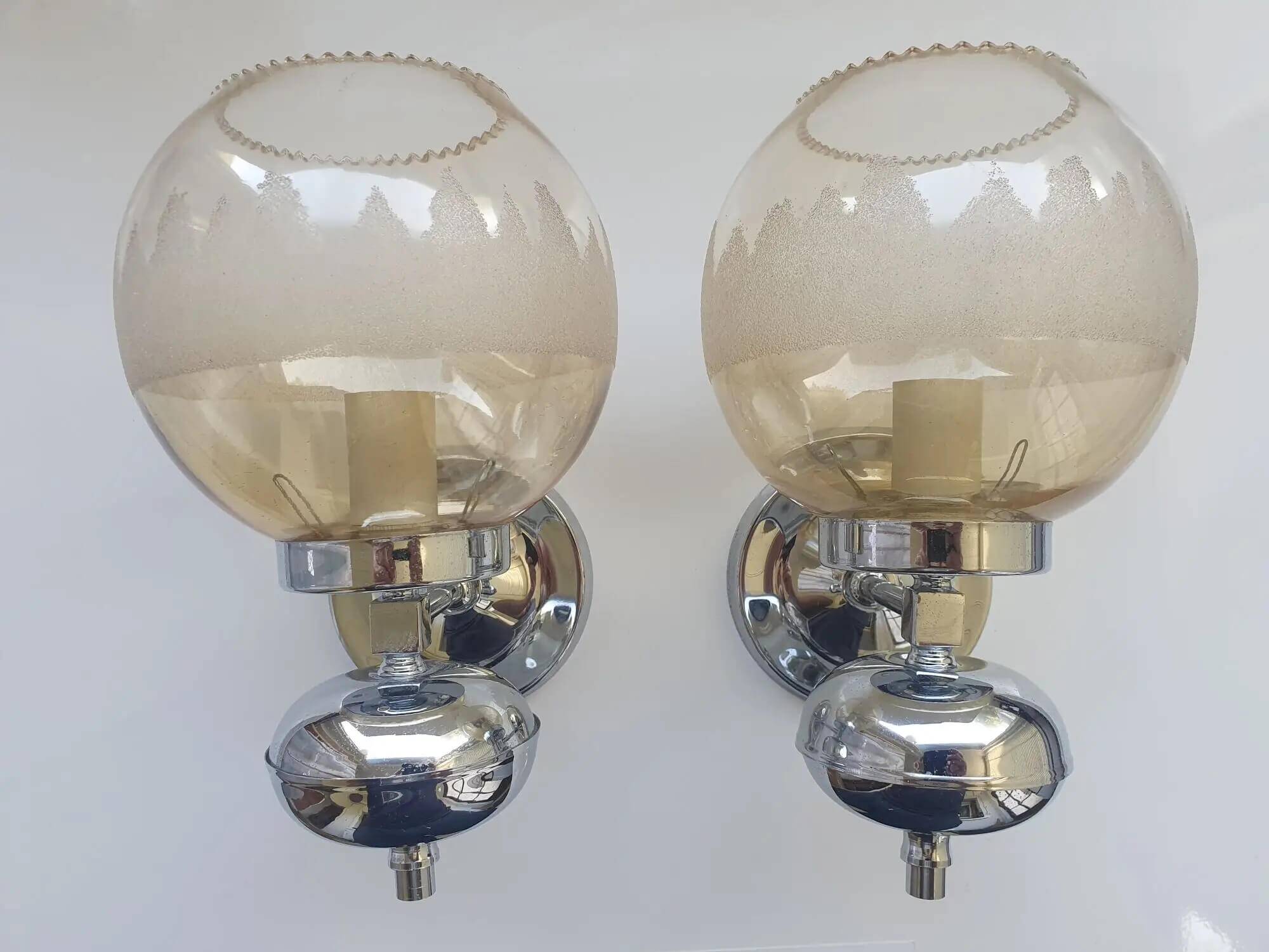 Pair of chrome metal wall lights with vintage sandblasted glass globes