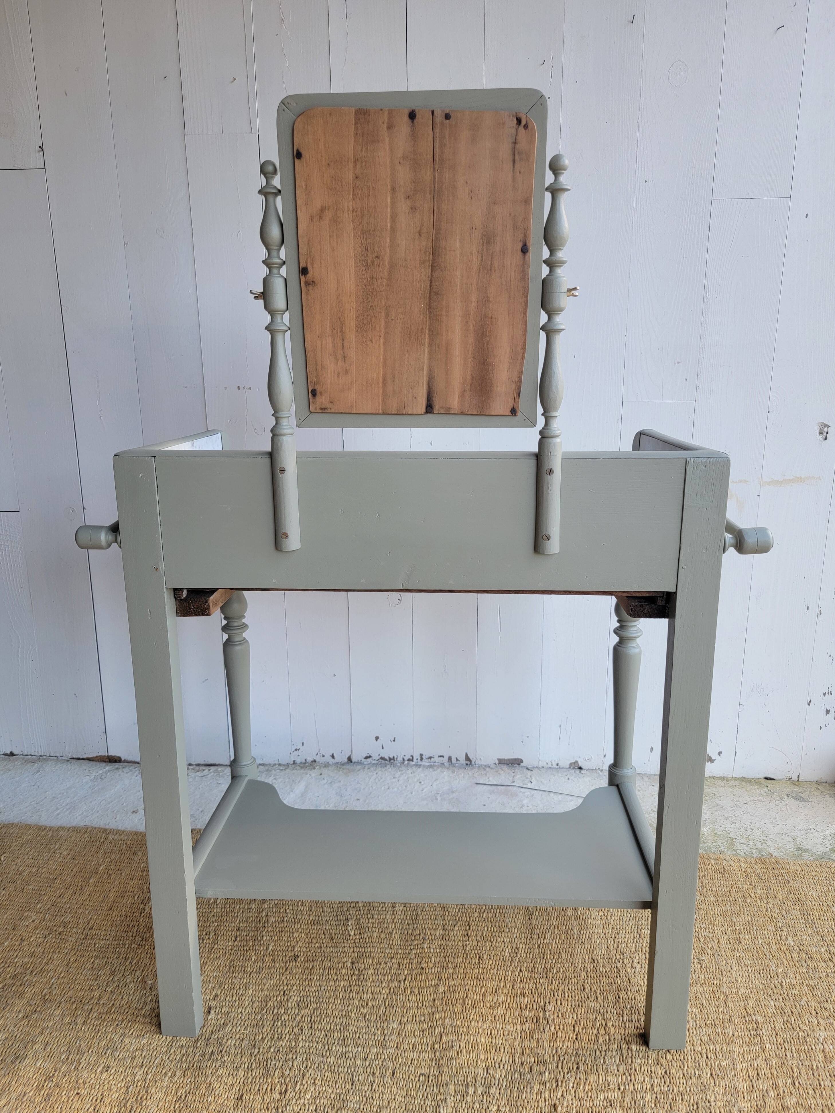 Antique wooden dressing table with marble top and mirror.