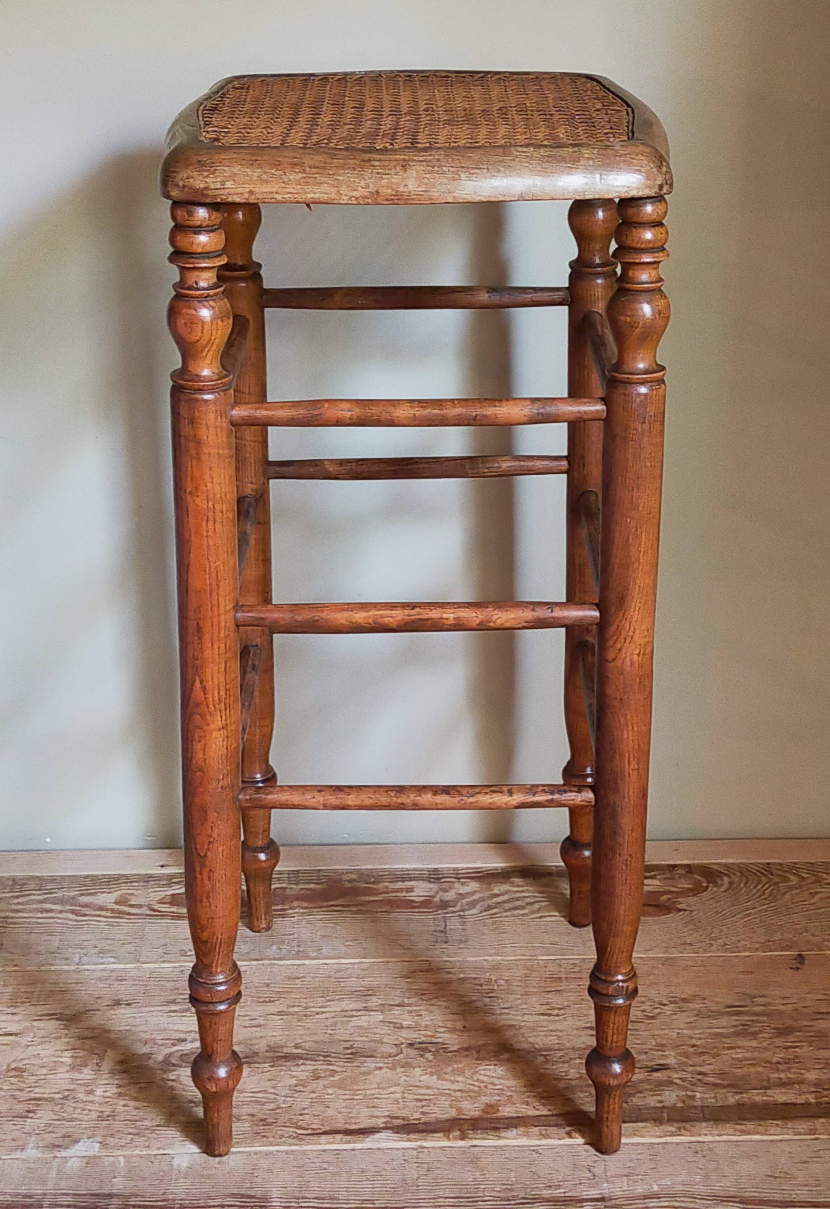 Antique stool with cane and turned wood