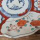 Antique Imari deep plate with red and blue floral decoration, 21.5cm.