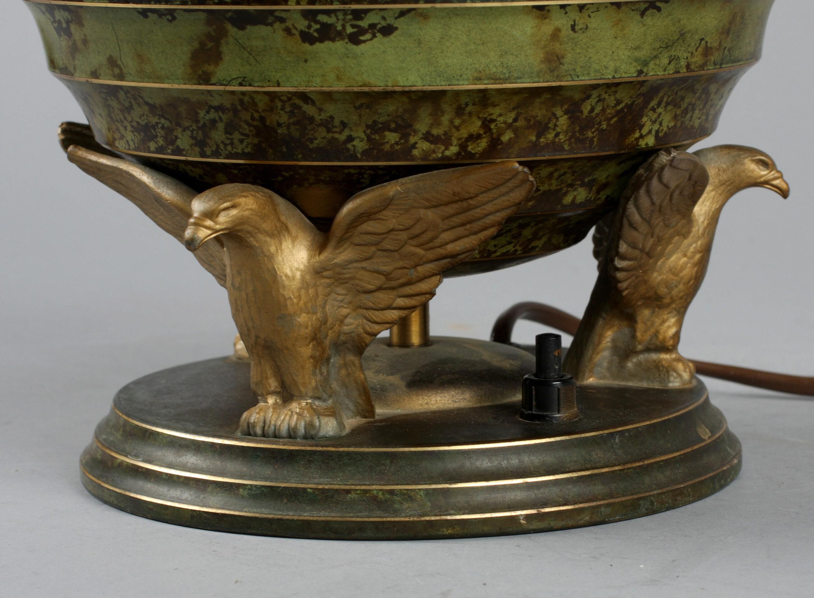 Art Deco table lamp in patinated bronze with eagles holding a globe, France 1940.