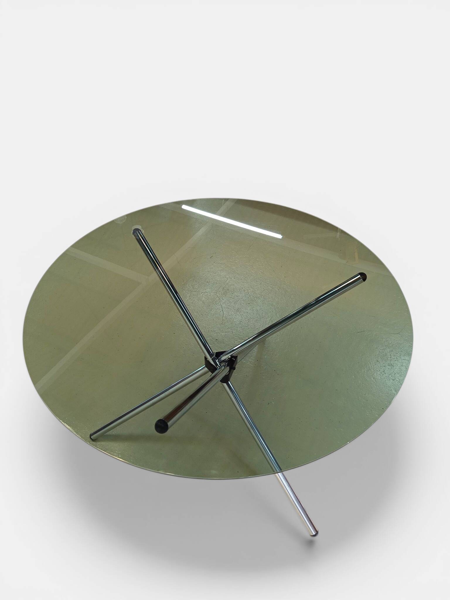 Vintage round table with smoked glass and foldable chrome legs.