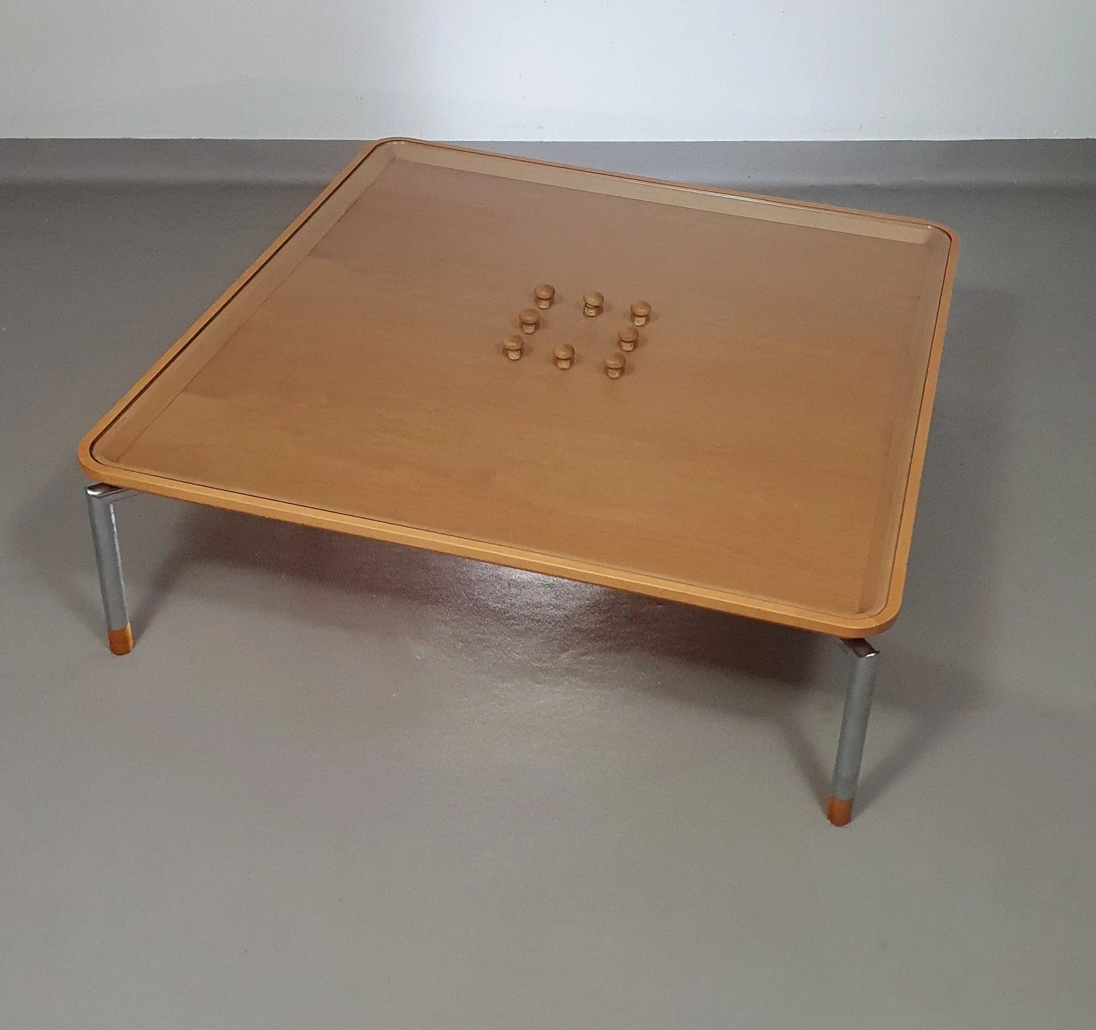 Rare coffee table 110 x 110 x height 35 cm with 8 flange wooden / cork caps in the glass top.