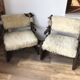 Set of 2 vintage wooden chairs with beige sheepskin seats, rustic style.