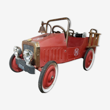 Old fire car with pedals, made of sheet metal.