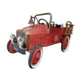 Old fire car with pedals, made of sheet metal.