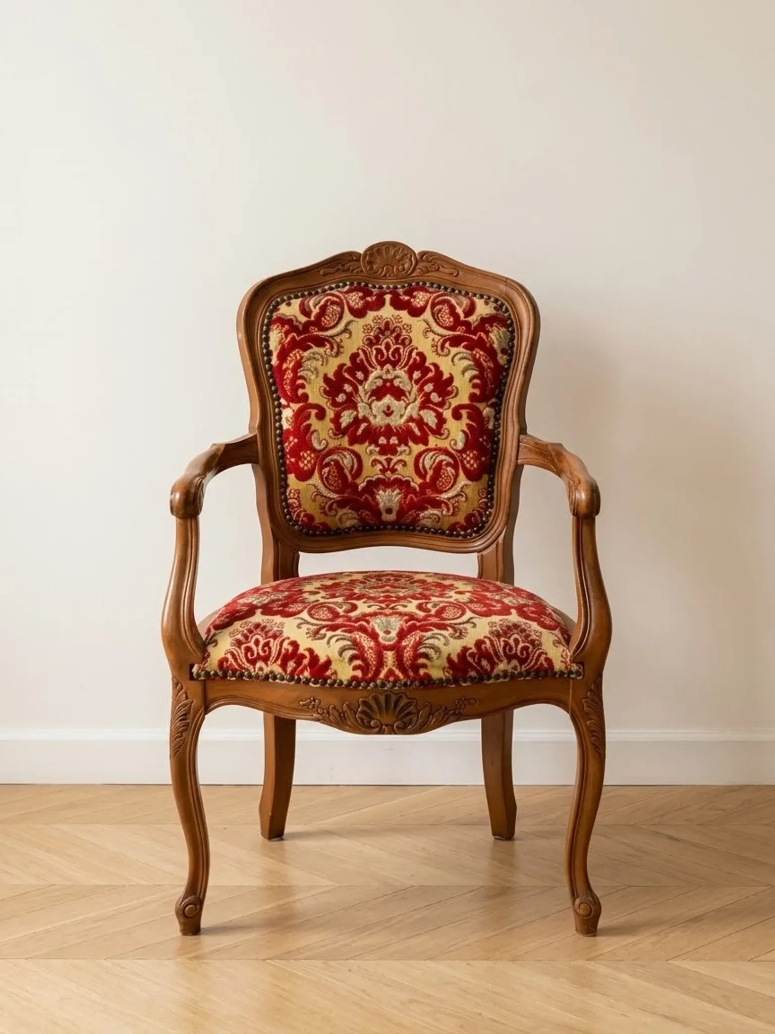 Louis XV style armchair in solid wood with red and gold damask fabric.