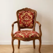 Louis XV style armchair in solid wood with red and gold damask fabric.