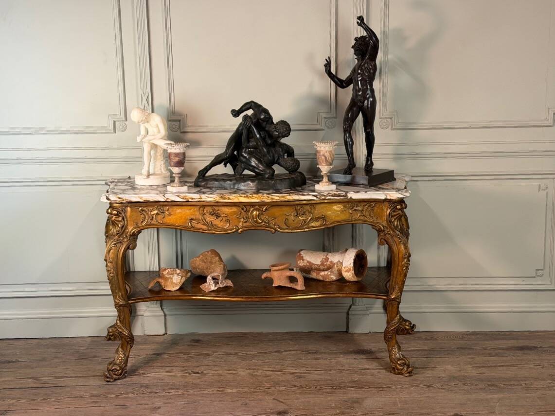 Golden wooden console, four legs adorned with sea monsters, purple breccia marble, around 1900.