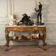 Golden wooden console, four legs adorned with sea monsters, purple breccia marble, around 1900.