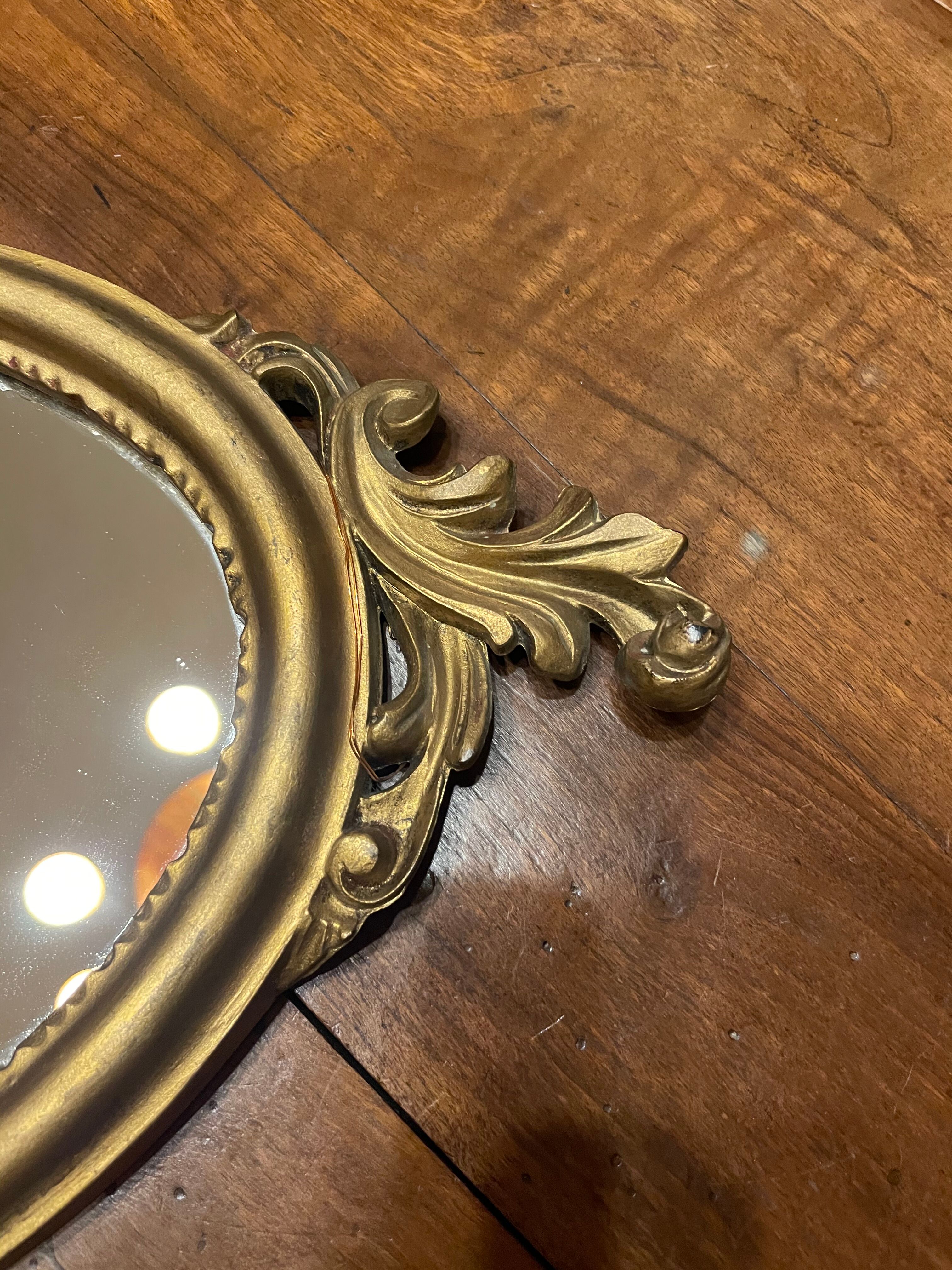 Golden oval mirror