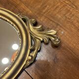 Golden oval mirror