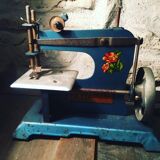 Old toy sewing machine in 1950s sheet metal