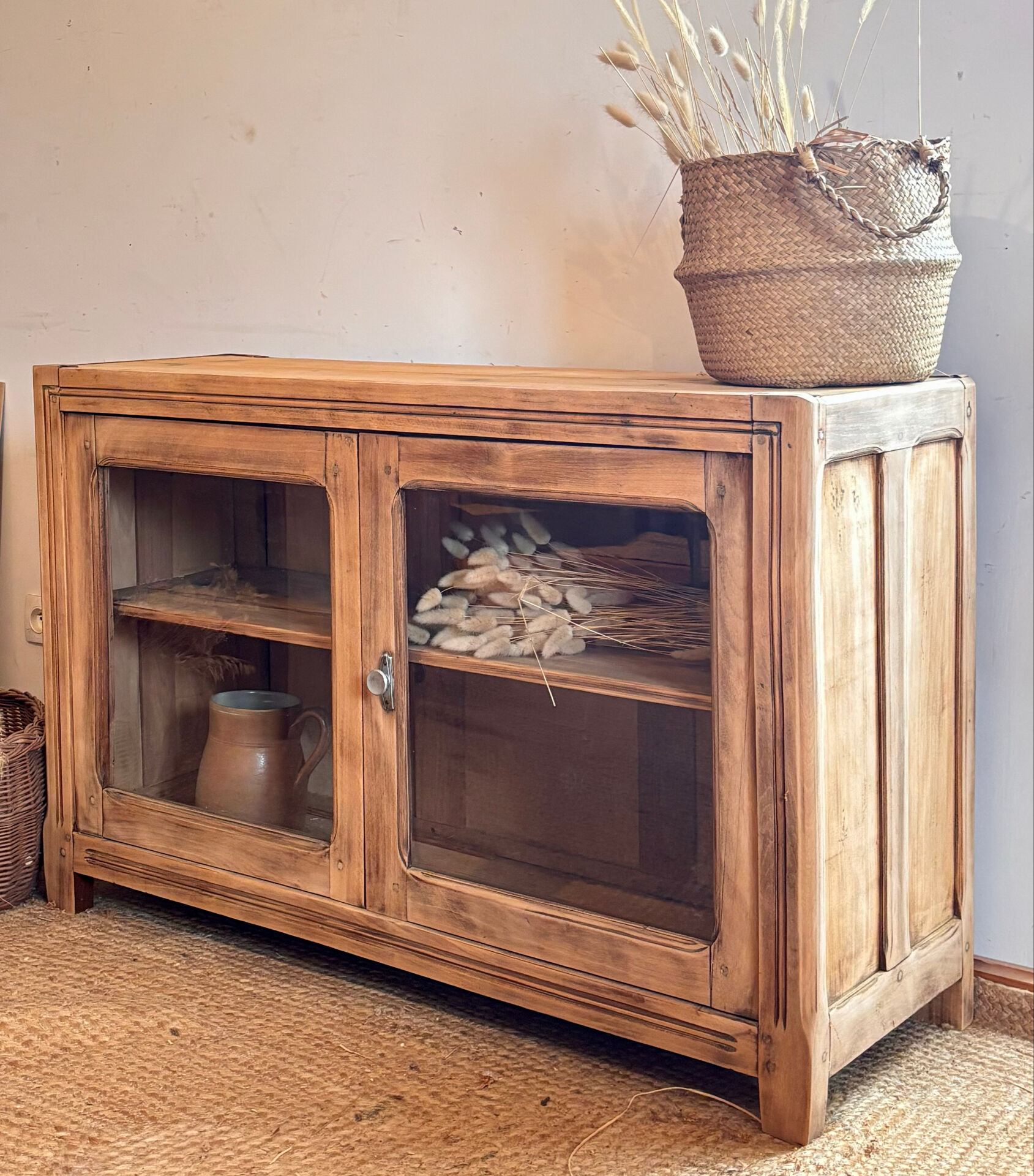 Old wooden buffet with a glass front in raw wood