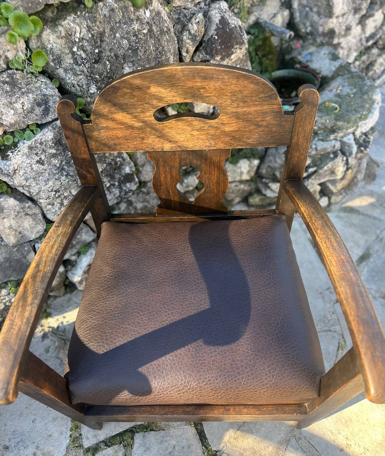 Pair of armchairs in stained wood and leather, 20th century
