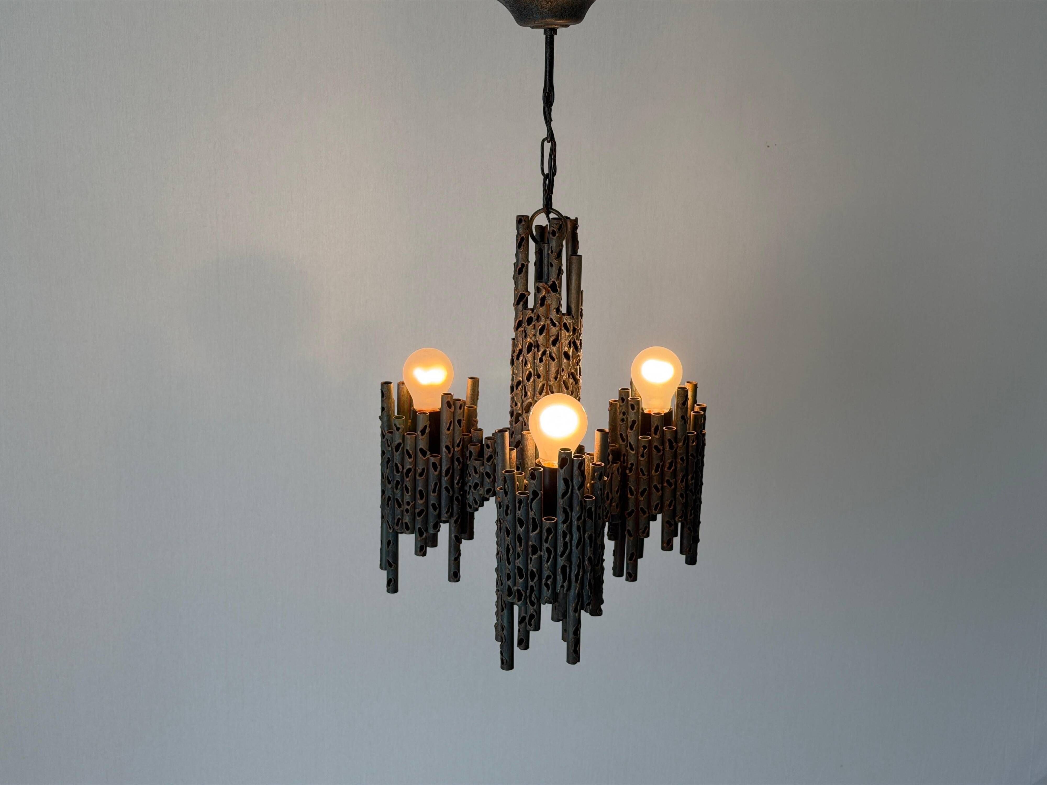 Three-armed suspended lamp in wrought iron, brutalist design, 1960s, Italy.