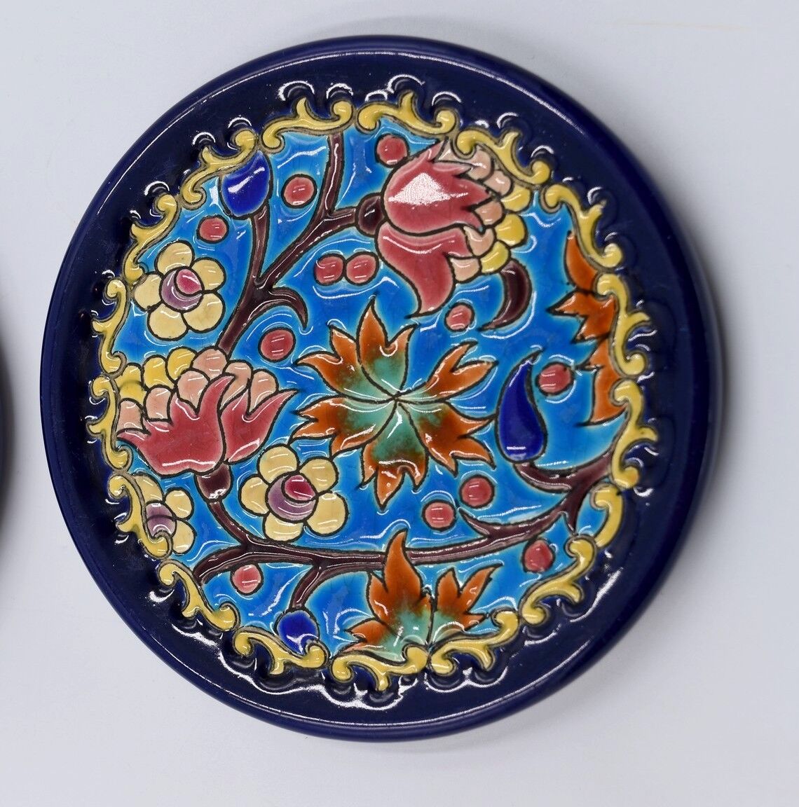 A flat bottom and two enamel bottle bottoms of Longwy