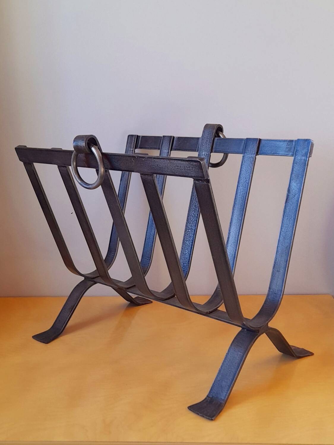 Brutalist magazine rack in forged steel, 1950.