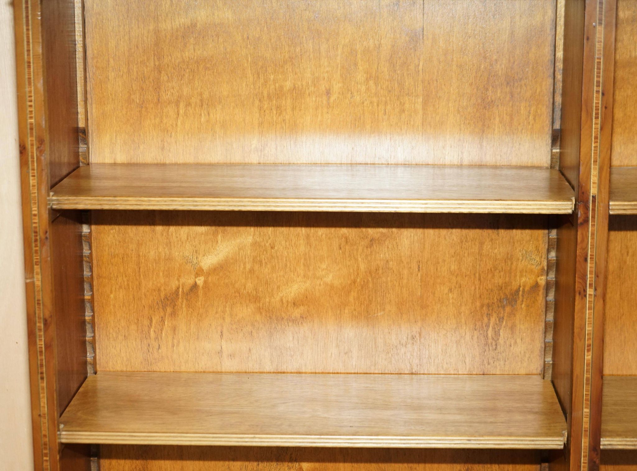 Pair of Sheraton Revival bookcases in satinwood, walnut, and yew.