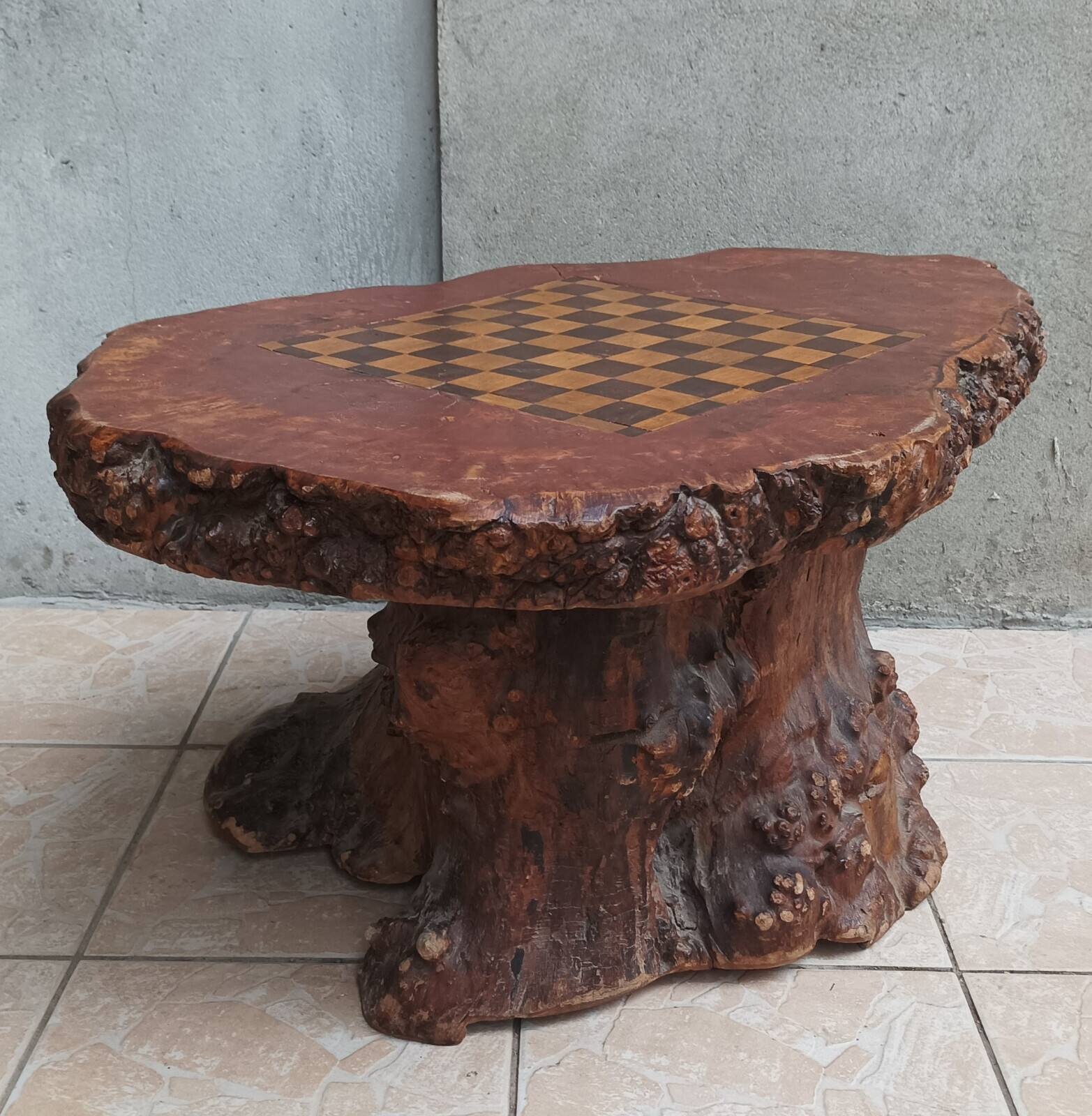 Brutalist chessboard coffee table made from tree stump.