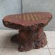 Brutalist chessboard coffee table made from tree stump.