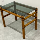 Blonde wood coffee table with smoked glass and leather bindings.