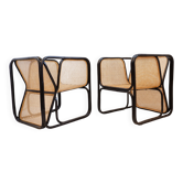 Pair of designer armchairs in curved wood and wicker
