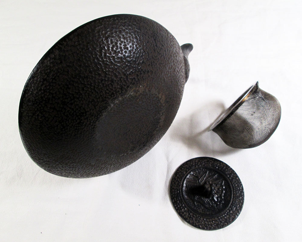 Antique cast iron teapot decorated