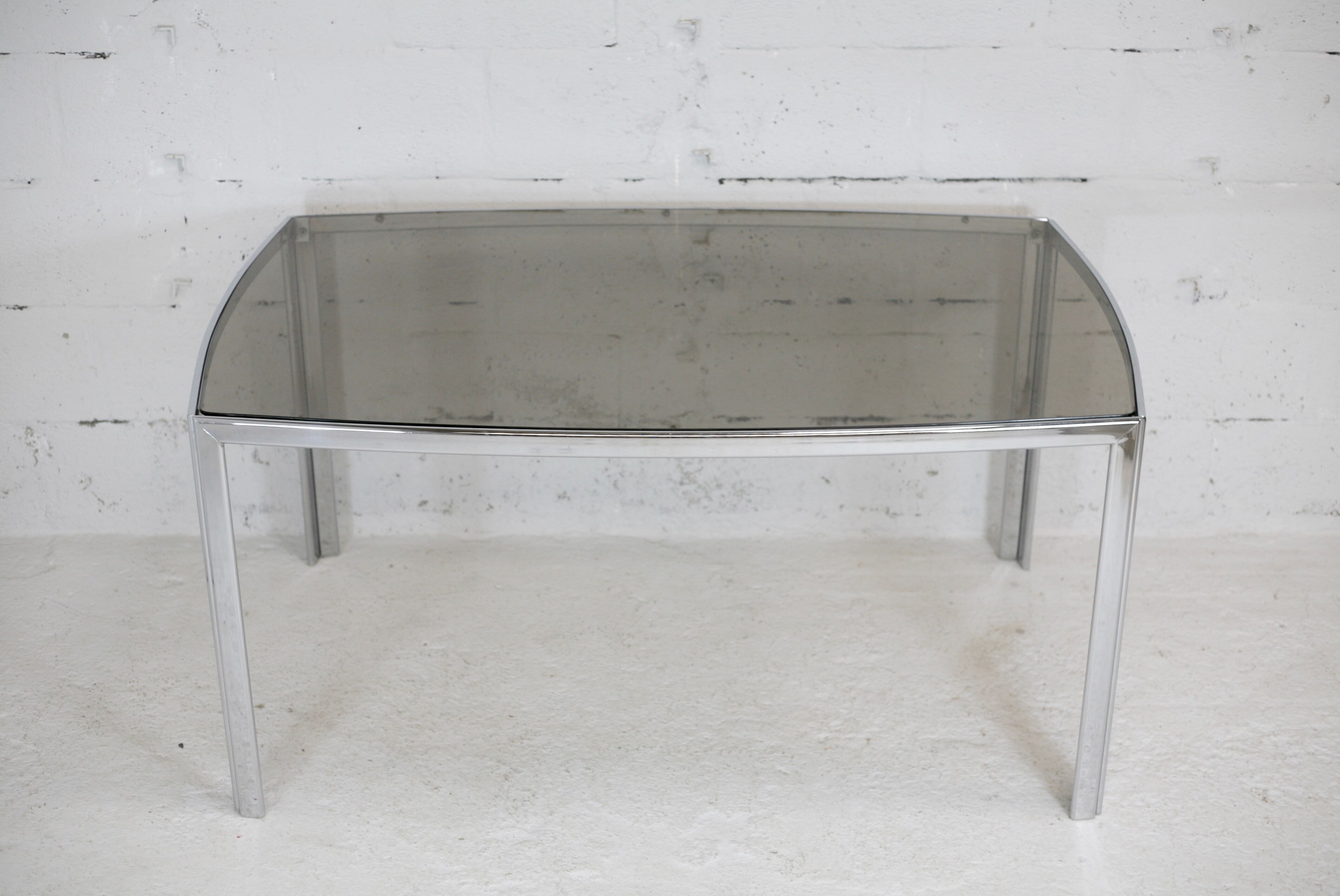 Living table. chrome metal, curved smoked glass slab, france, circa 1970.