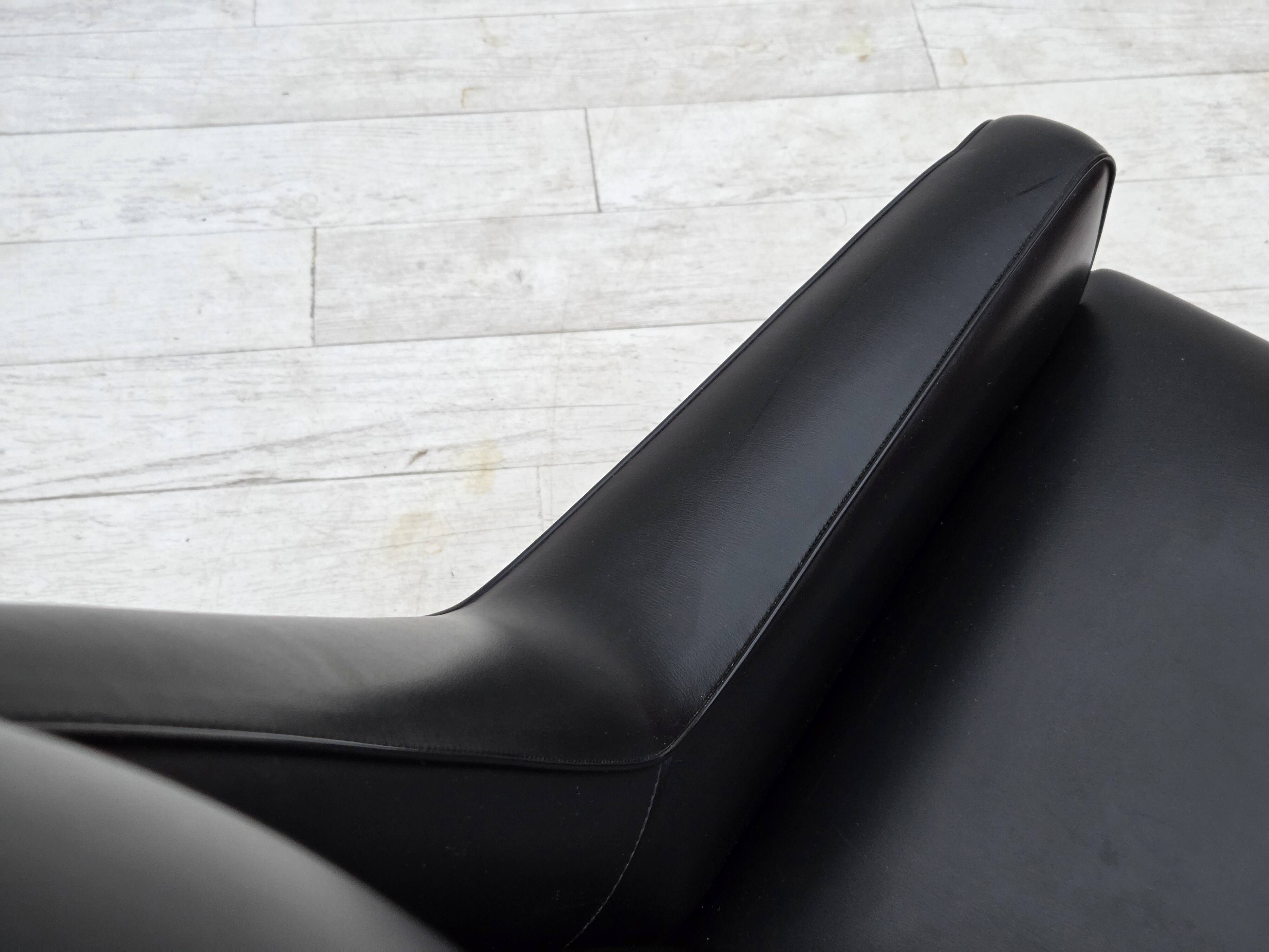 1970s, Danish highback armchair, black artificial leather, teak wood legs.