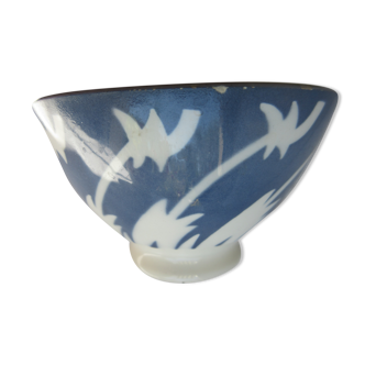 Bowl decorated with white herbs pushed by the wind on a gray background