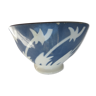 Bowl decorated with white herbs pushed by the wind on a gray background