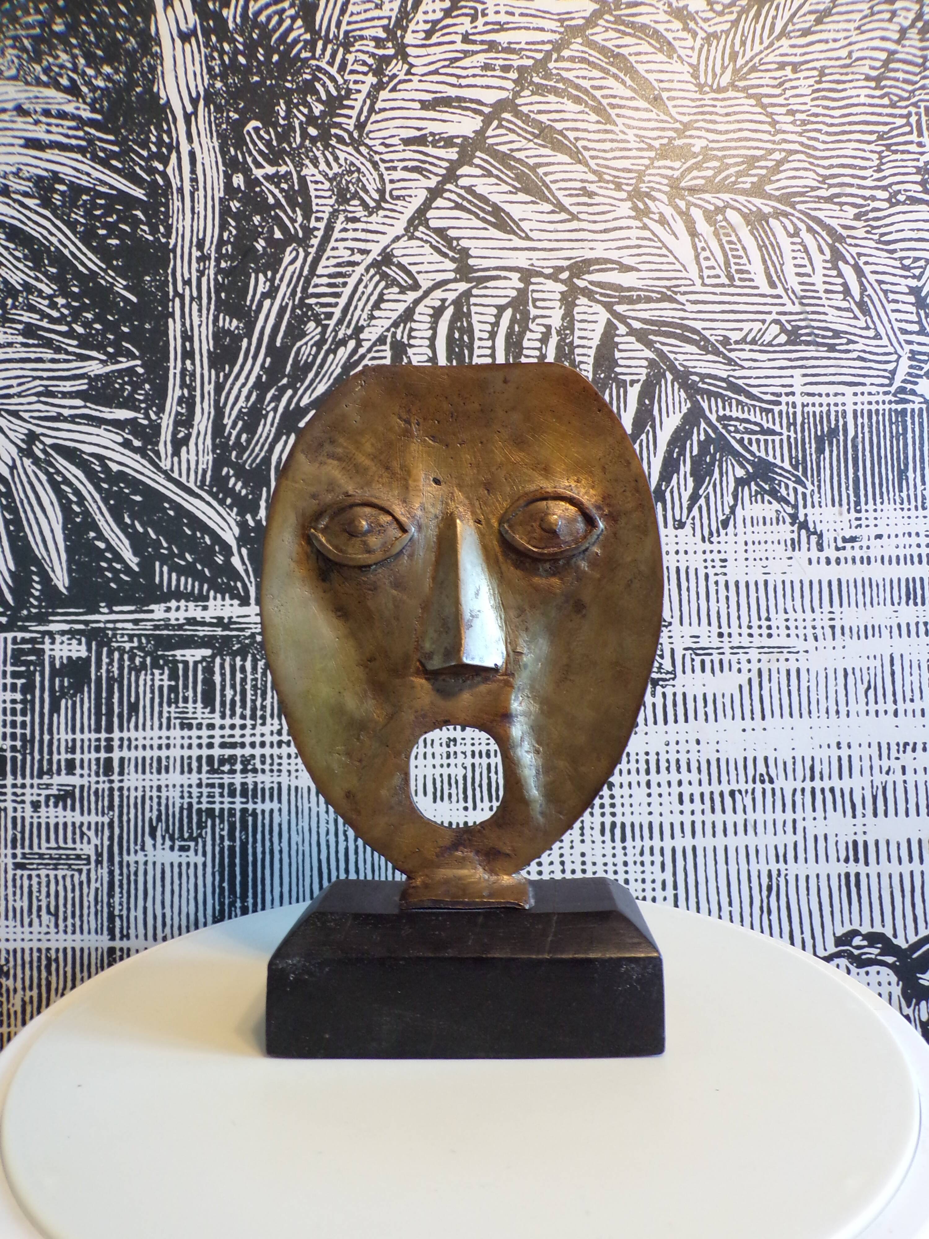 brutalist bronze face sculpture