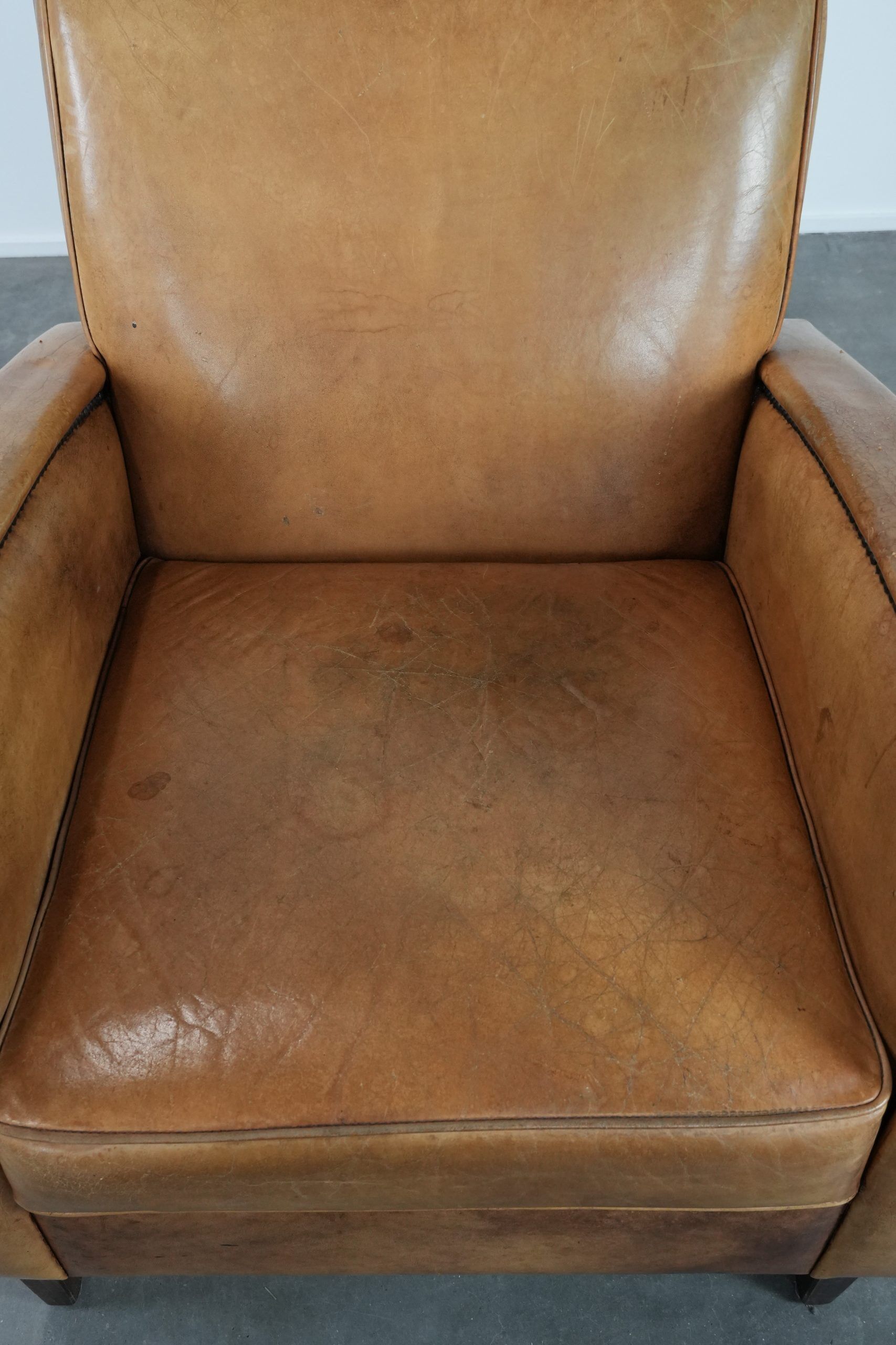 Luxury armchair made of cowhide leather with a beautiful warm colour scheme