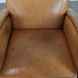 Luxury armchair made of cowhide leather with a beautiful warm colour scheme